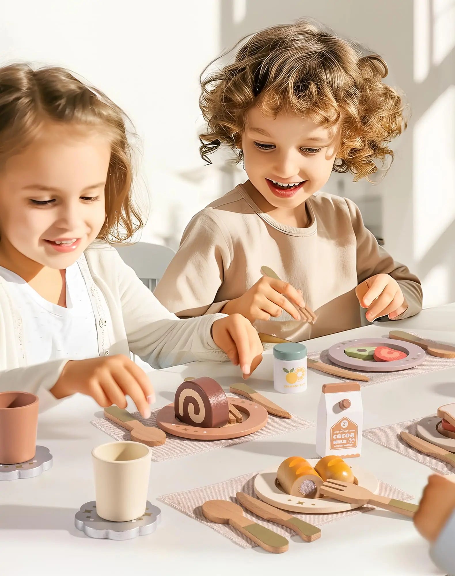 Two children playing with toy food and utensils at a table.