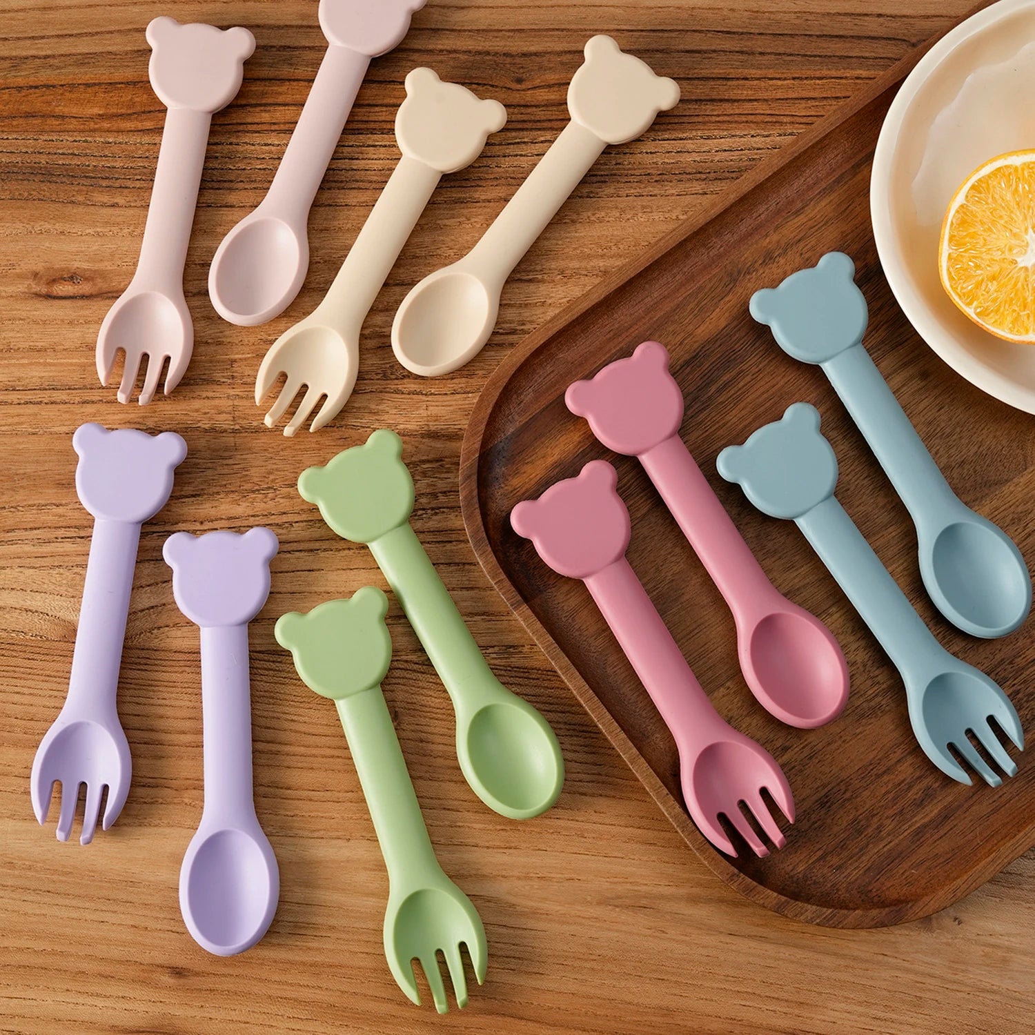 Bear spoon and fork sets laid out on a wooden table
