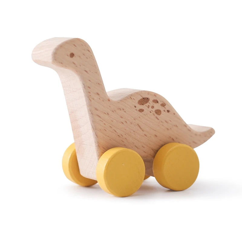 Wooden toy dinosaur with yellow wheels on a white background