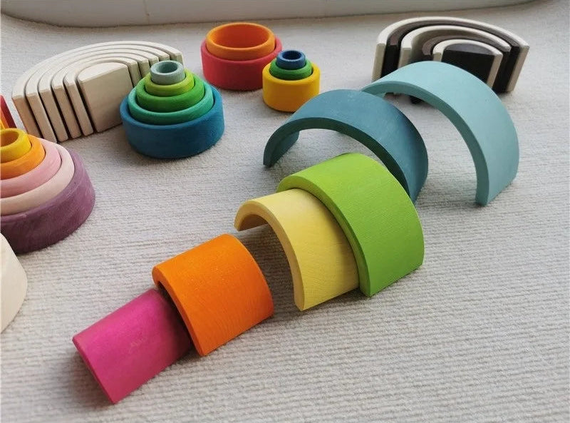 Colorful wooden stacking archs on a textured surface