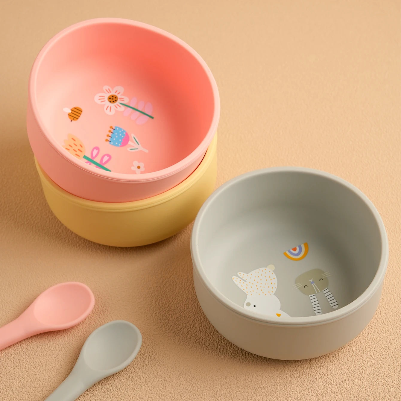 Grey, pink and yellow cartoon print silicone weaning bowls with baby spoons