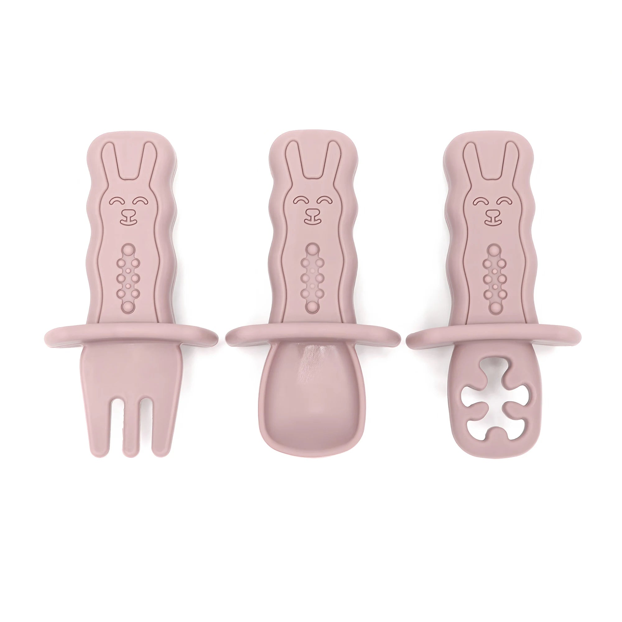 Set of three pink bunny-shaped utensils on a white background