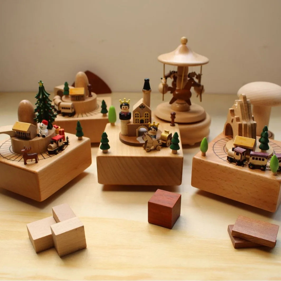 Set of wooden toy figures and buildings on a wooden surface