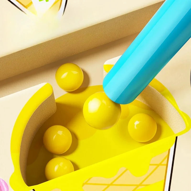 Yellow toy with blue handle and yellow balls on a beige surface