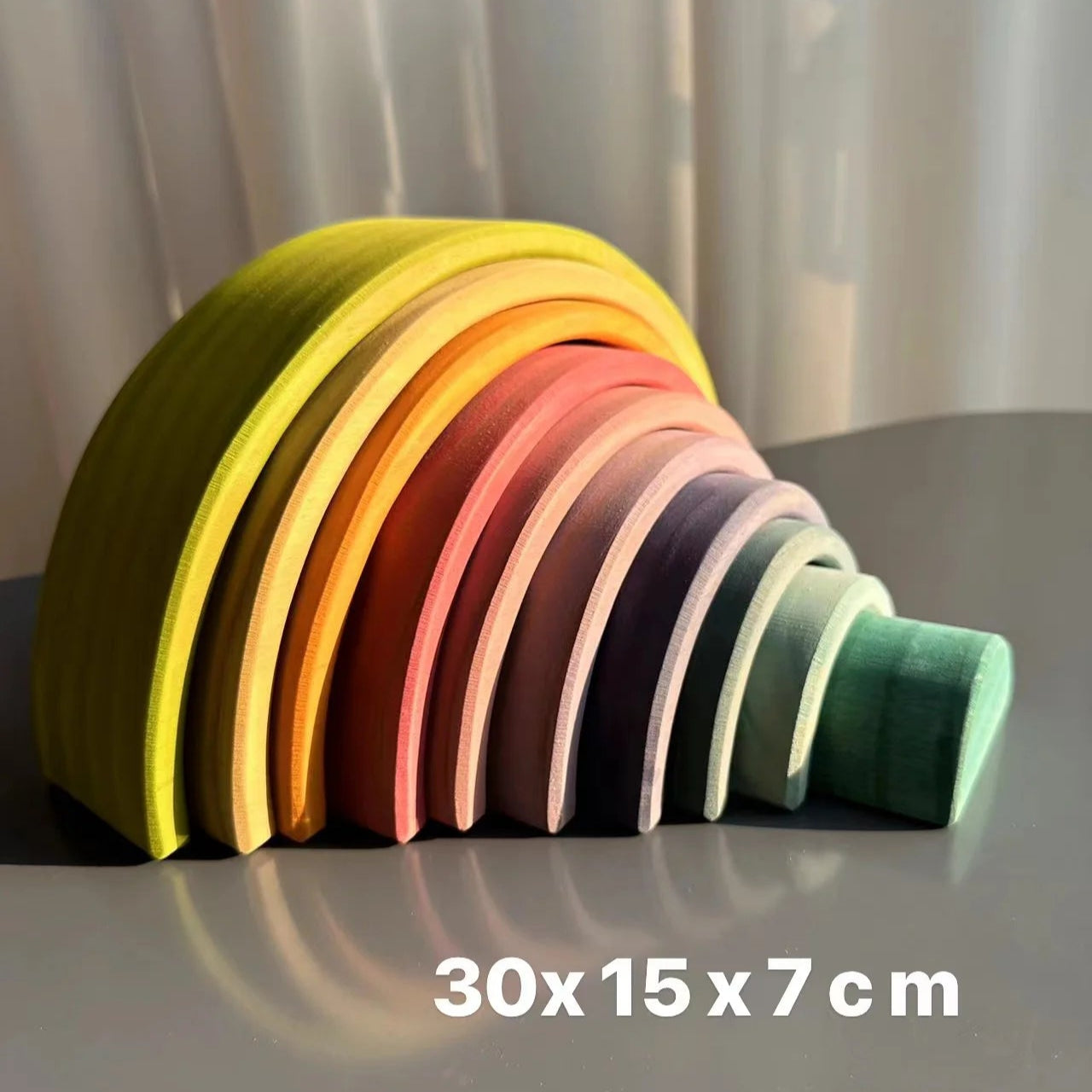 Colorful wooden toy arch on a gray surface with dimensions displayed.