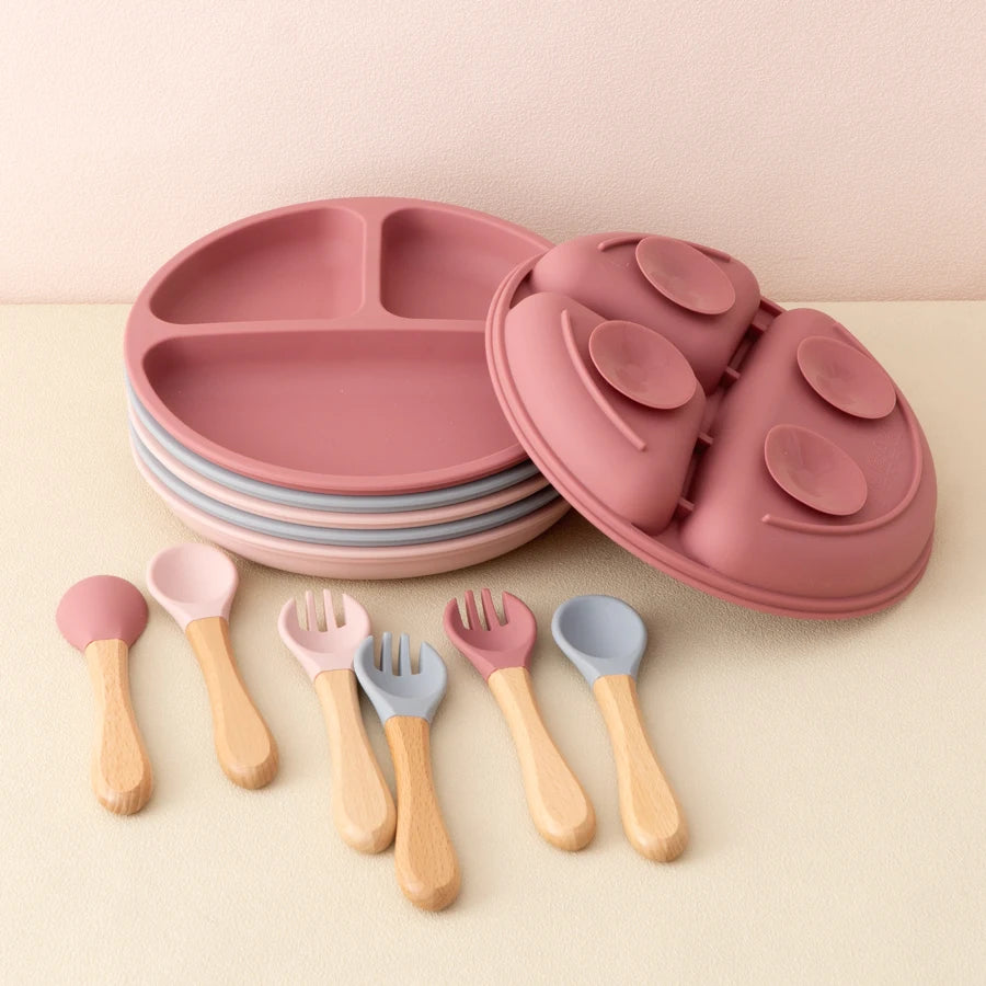 Stacked divided plates with wooden spoons and forks