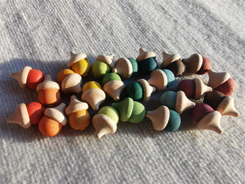 Colorful wooden acorn-shaped objects on a textured surface