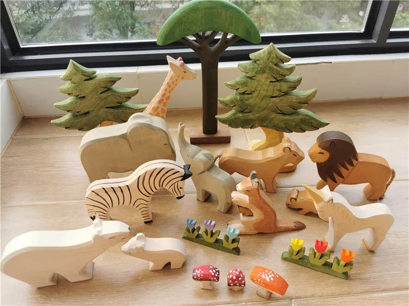Set of wooden animals and trees on a wooden floor with a window in the background.