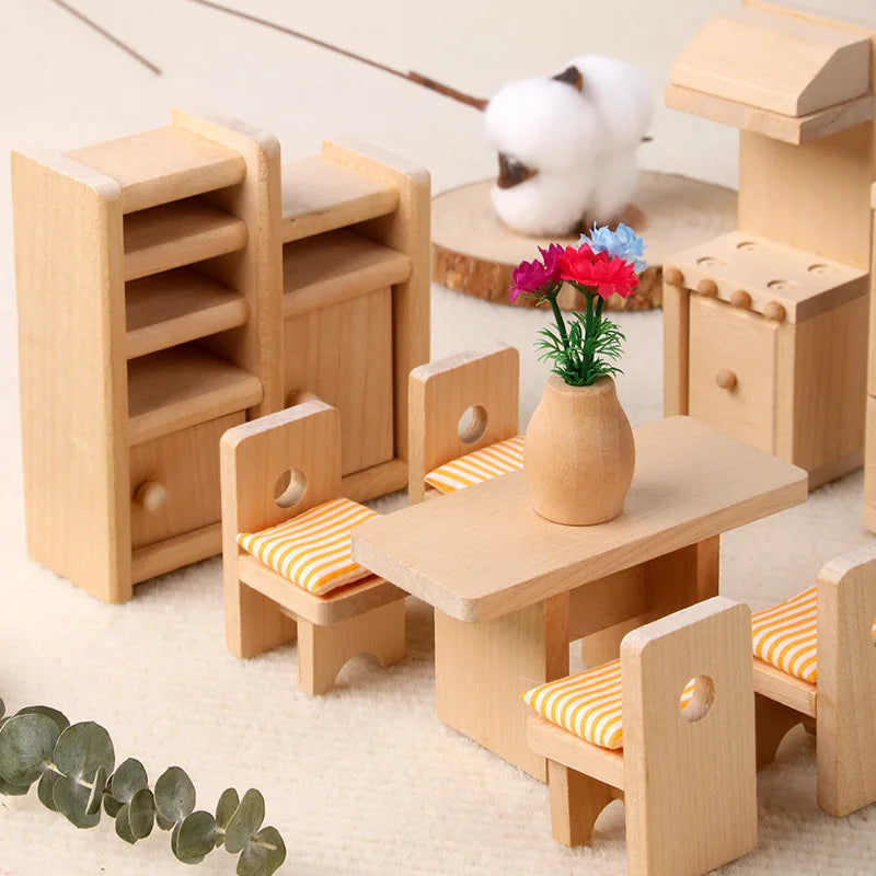 Set of wooden toy furniture including a table and chairs on a light surface.