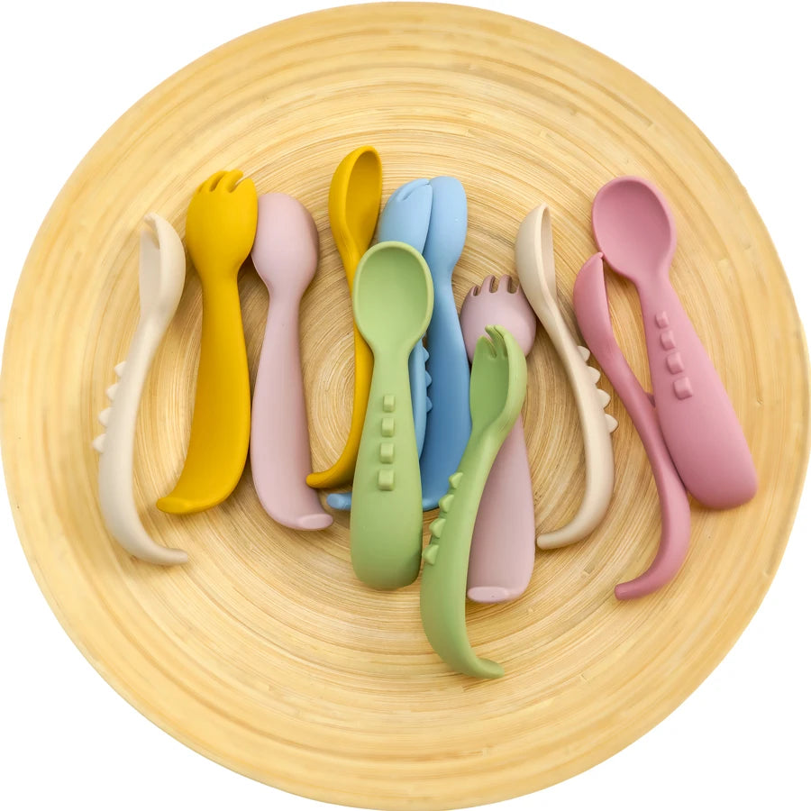 Silicone spoons and forks on a round bamboo plate
