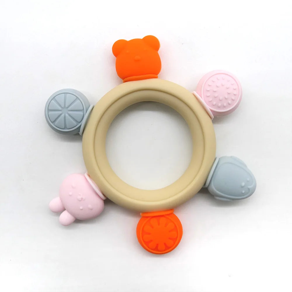 Colorful silicone teething ring with various textures on a white background