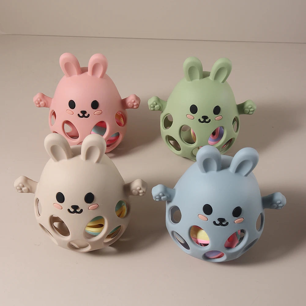 Four colorful rabbit-shaped toys on a beige background