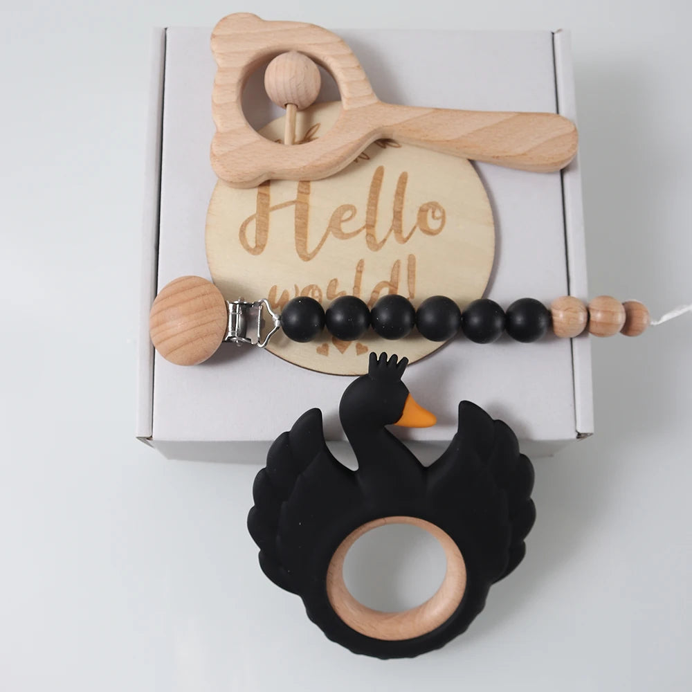 Wooden and silicone teething toy with 'Hello world!' message on a white background