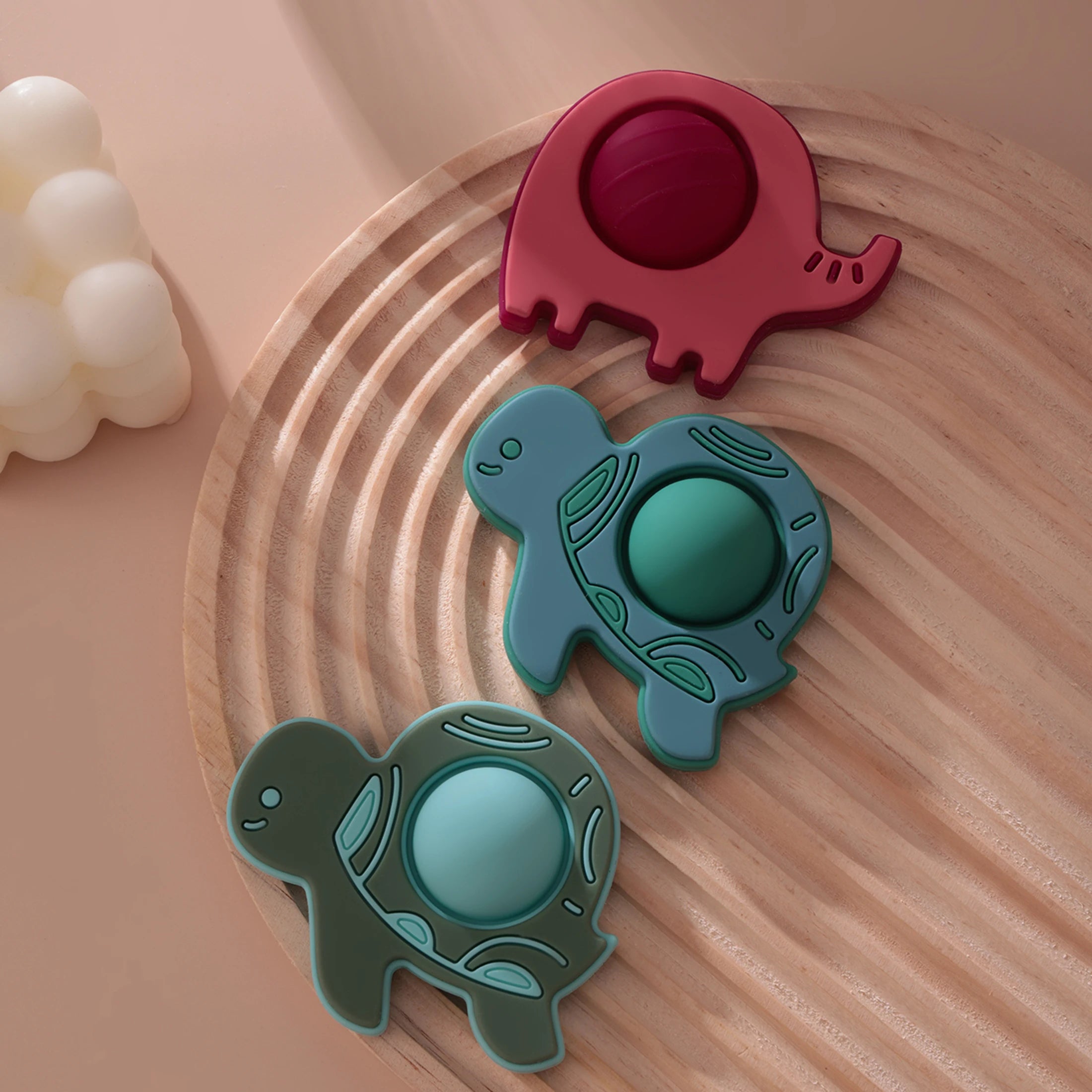 Elephant and turtle pop teethers on a rippled tray