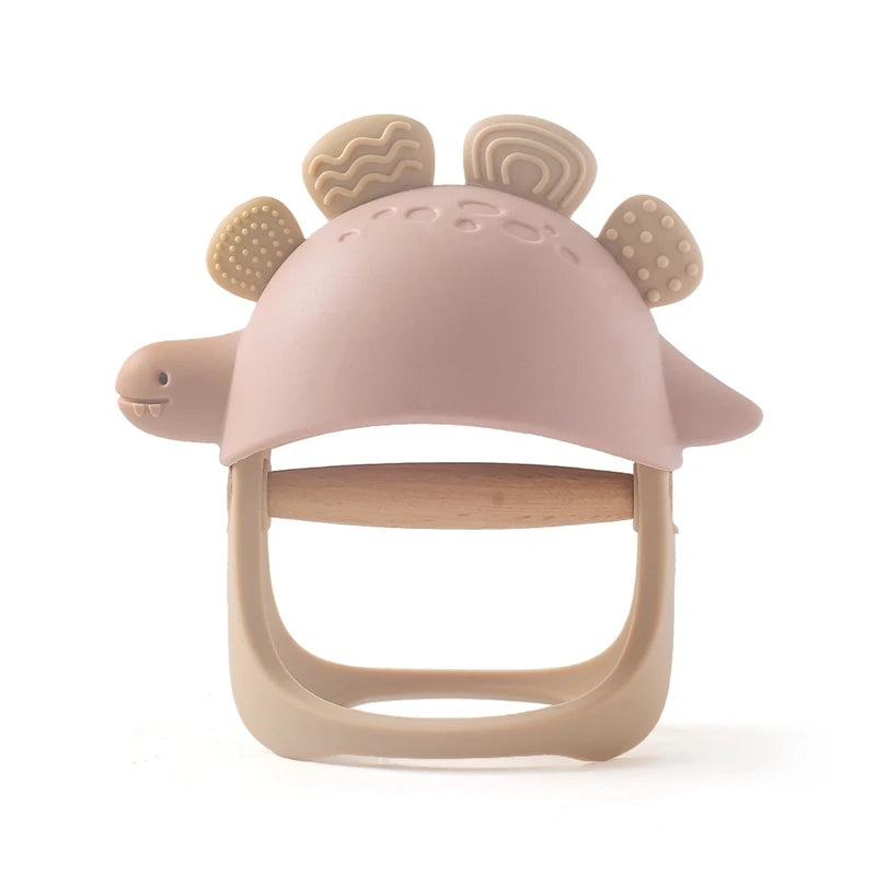 Pink and beige baby teether with dinosaur design on a white background
