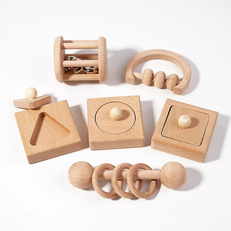 Set of wooden baby toys on a white background