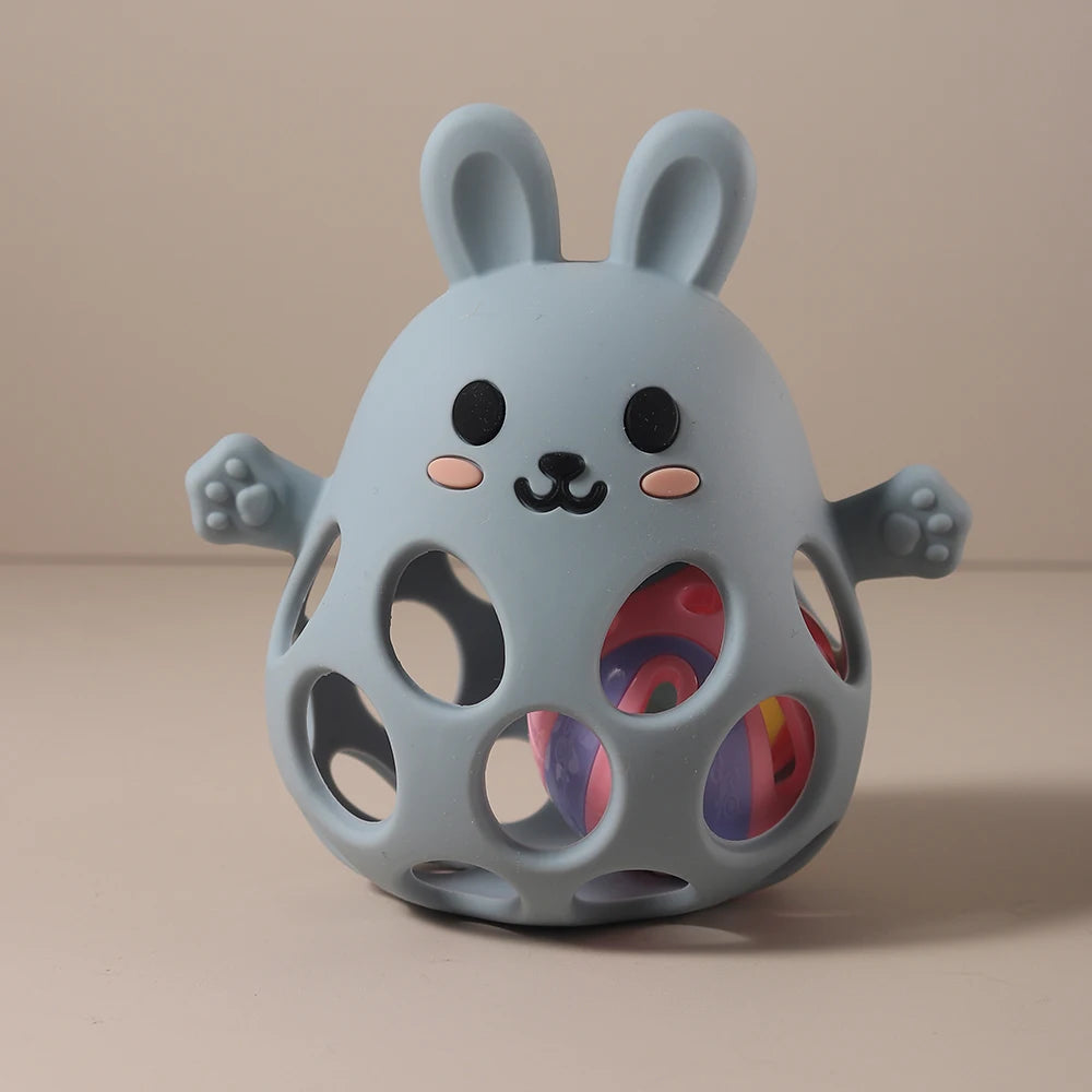 Gray rabbit-shaped toy with colorful interior on a beige background