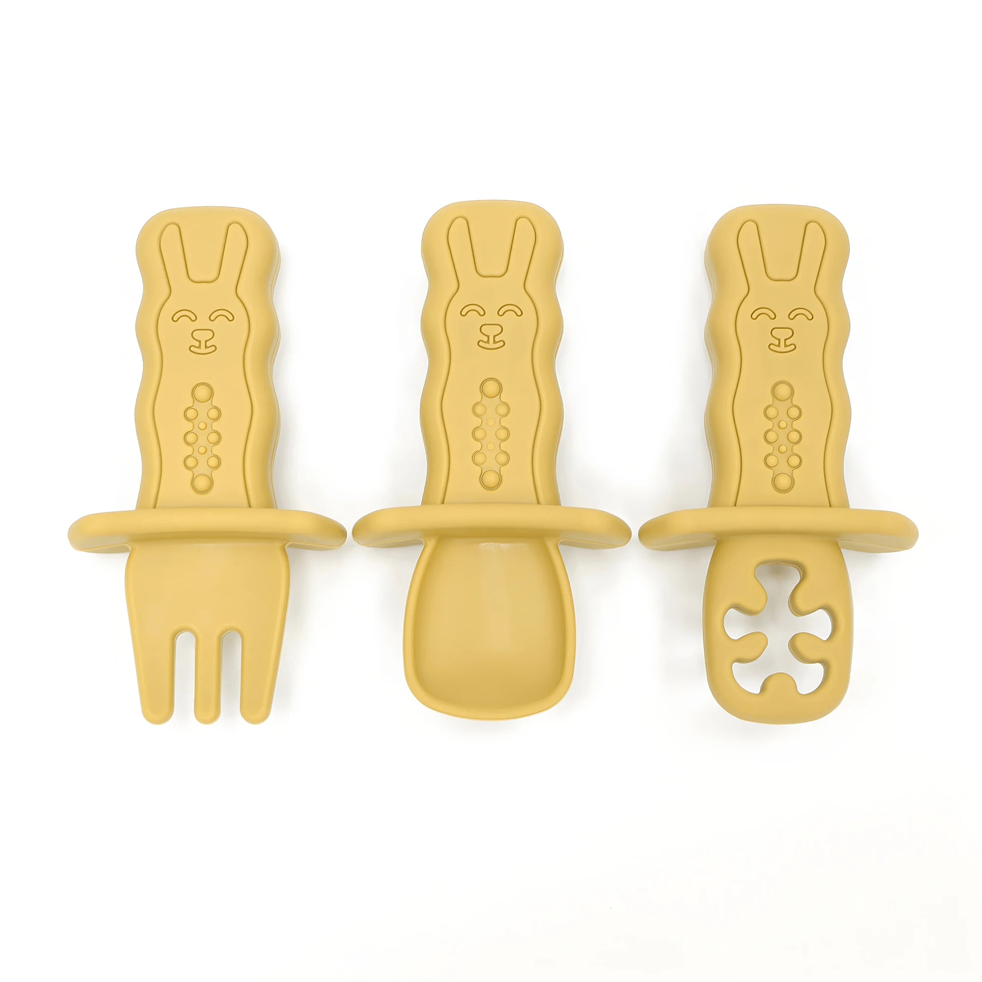 Three yellow baby feeding utensils with rabbit design on a white background