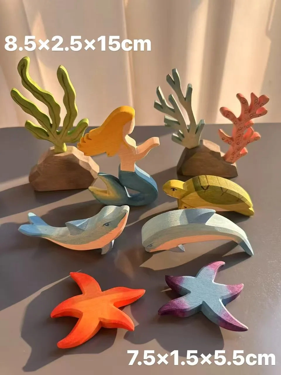 Set of colorful sea-themed wooden figures on a gray surface with measurements displayed.