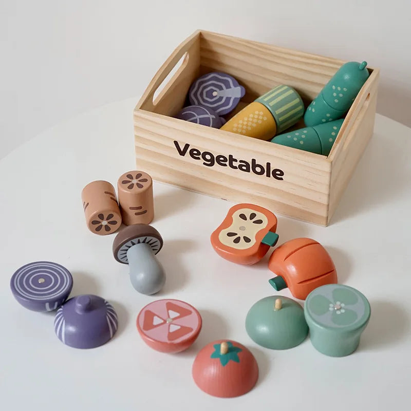 Set of colorful wooden toy vegetables in a box labeled 'Vegetable' on a white background.