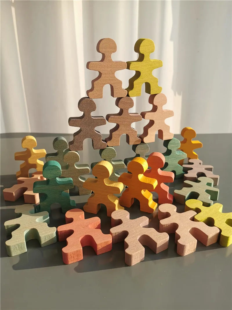 Colorful wooden puzzle pieces stacked on a gray surface with a white curtain background