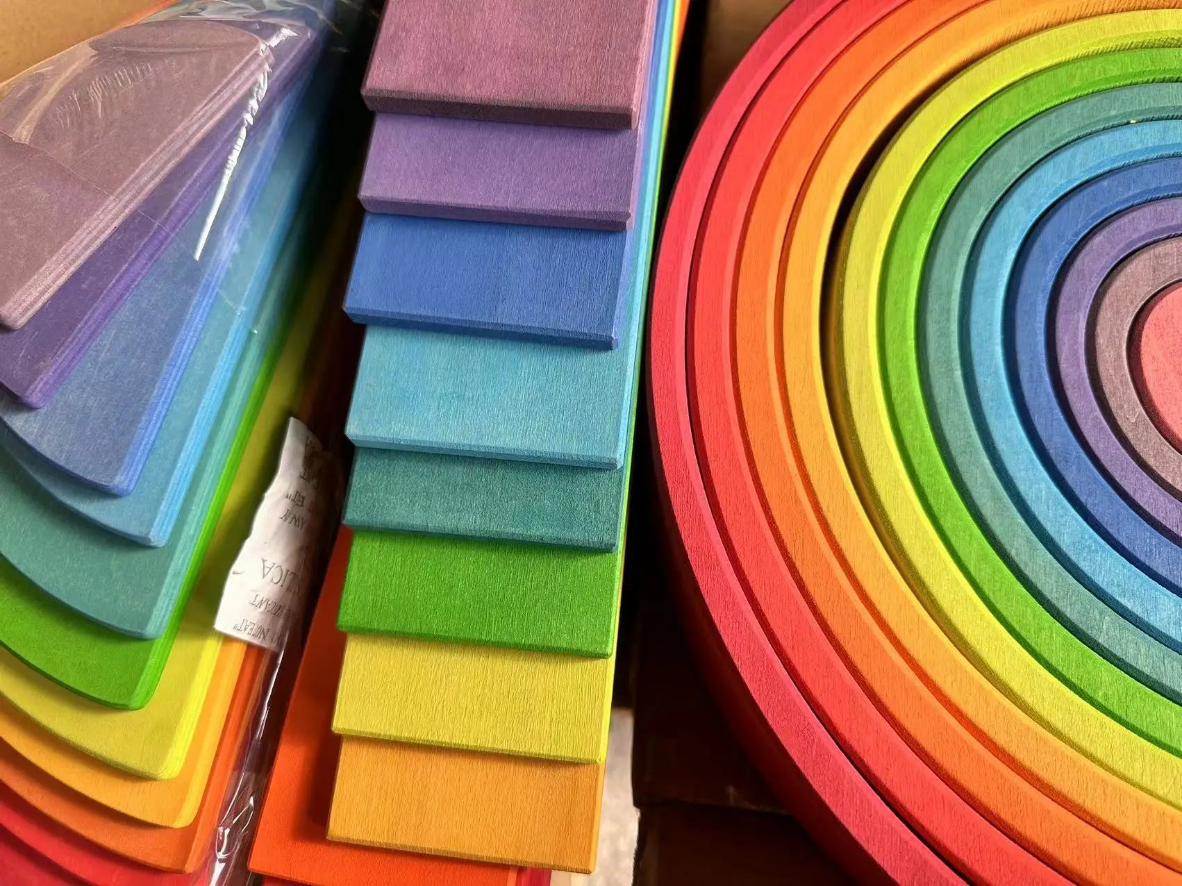Stacks of colorful foam sheets in a rainbow pattern.