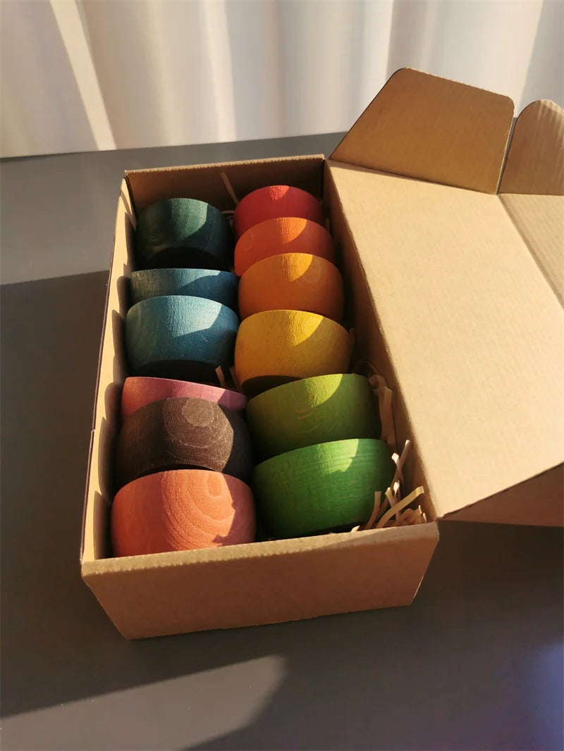 Box of colorful ceramic cups on a gray surface