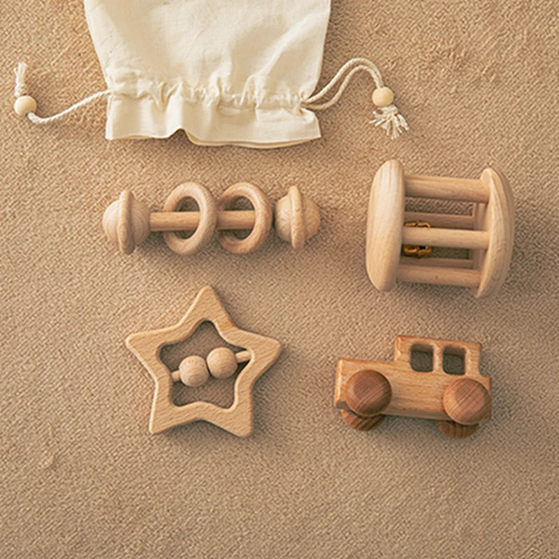 Set of wooden toys including a star-shaped rattle, car, and cylindrical rattle on a beige surface.