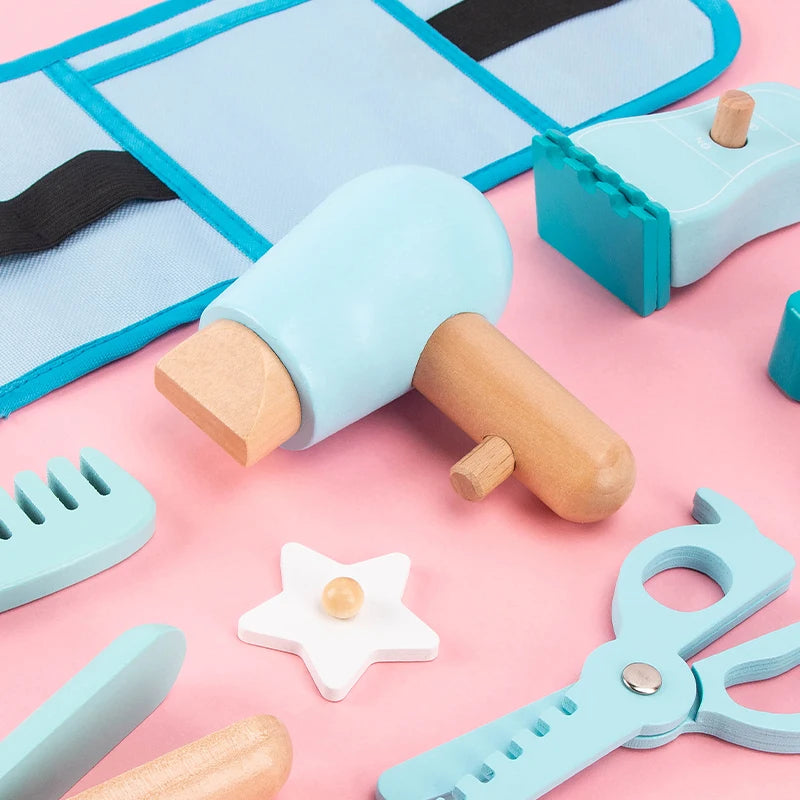 Set of wooden kitchen utensils including a rolling pin, spatula, and cookie cutters on a pink background.