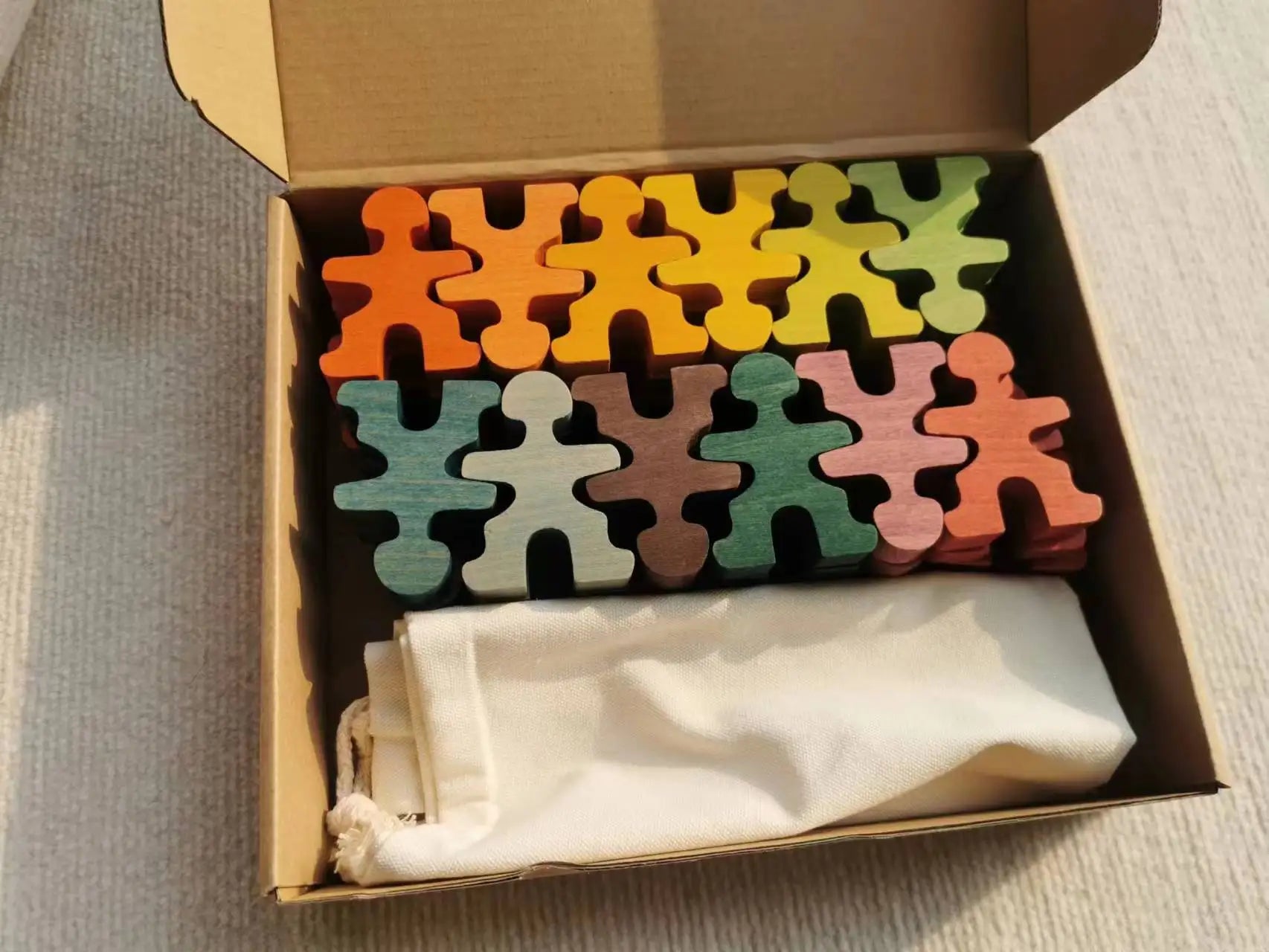 Colorful puzzle pieces in a box with a white cloth inside