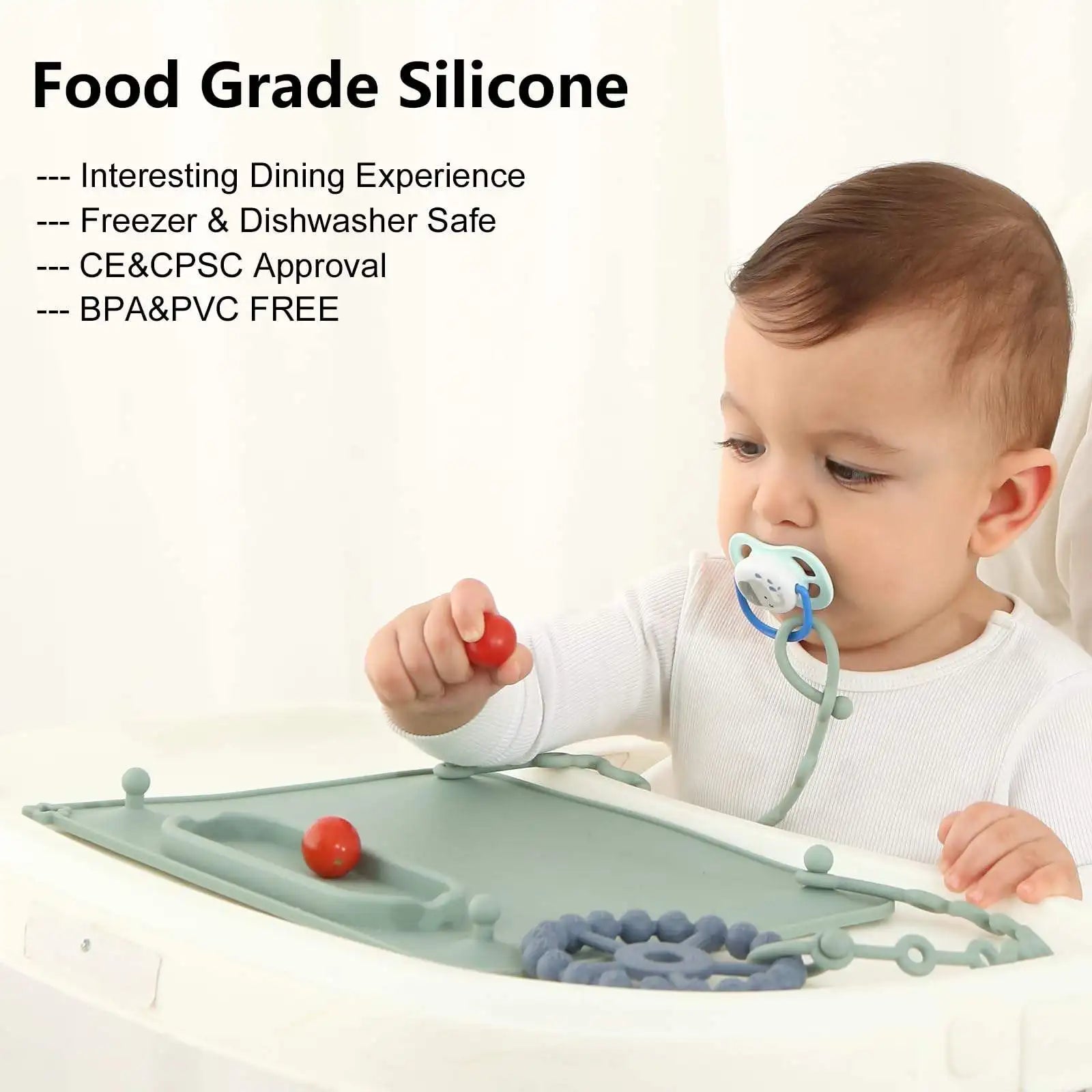 Grey suction mat on a tray with a pacifier clipped to a strap