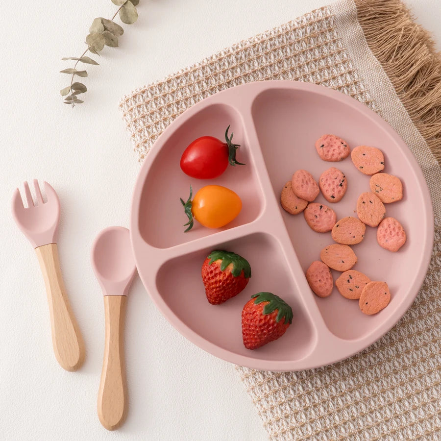 Light pink plate with strawberries, crackers and utensils