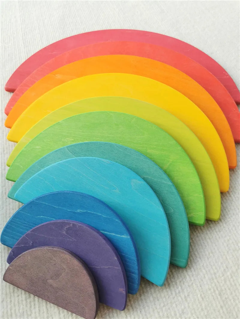 Set of colorful wooden wedges in a rainbow pattern on a textured surface