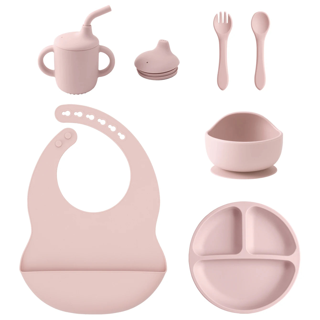 A coordinated baby feeding set in a soft dusty pink color, including a handled sippy cup with straw, a small lidded cup, a fork, a spoon, a silicone bib, a suction bowl, and a three-compartment divided plate on a plain white background.