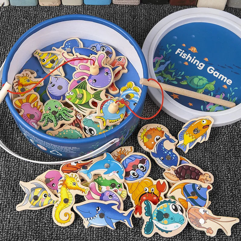 Wooden fishing game with colorful fish figures and a blue bucket on a dark surface.