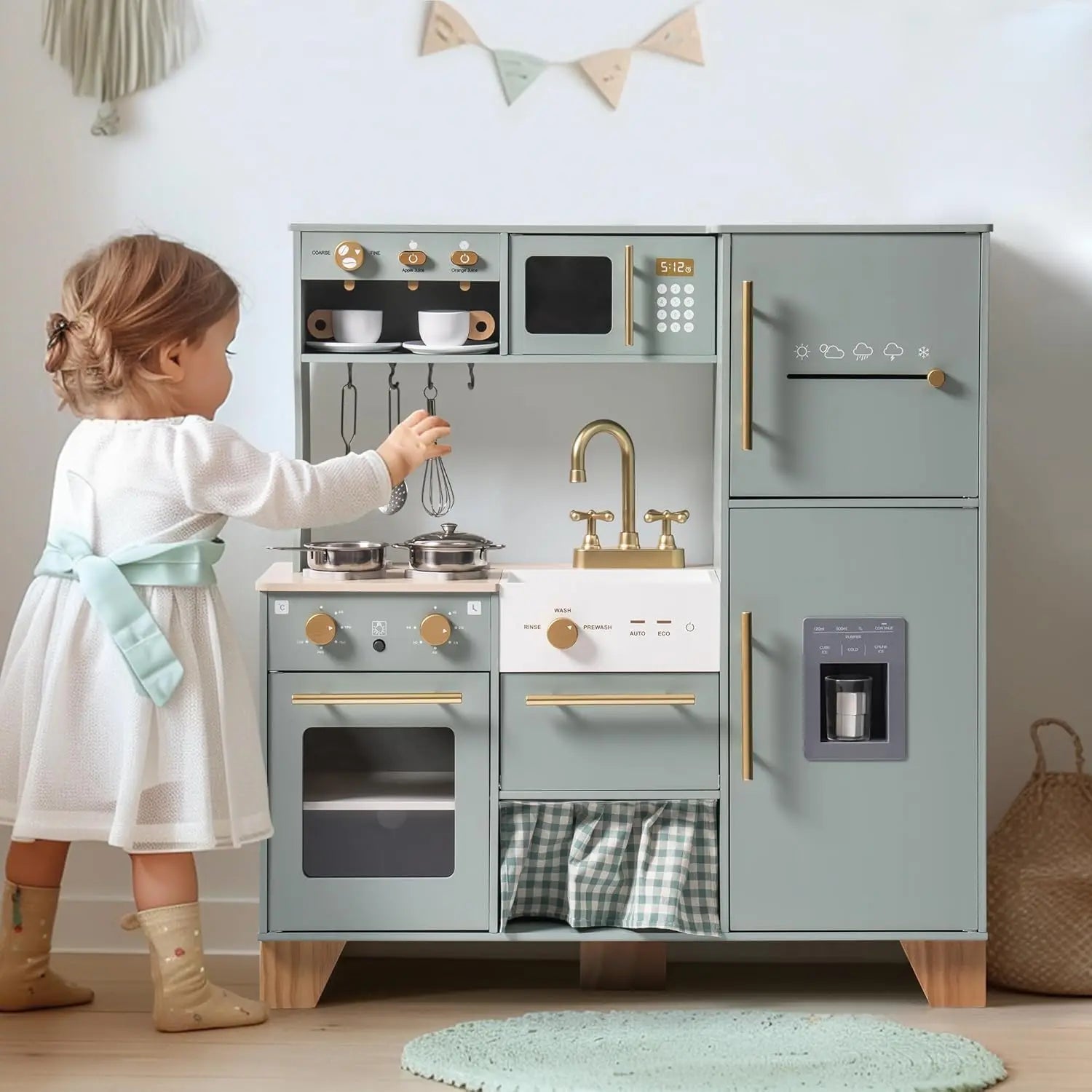 Child playing with a toy kitchen set in a room with a light blue rug and white walls.