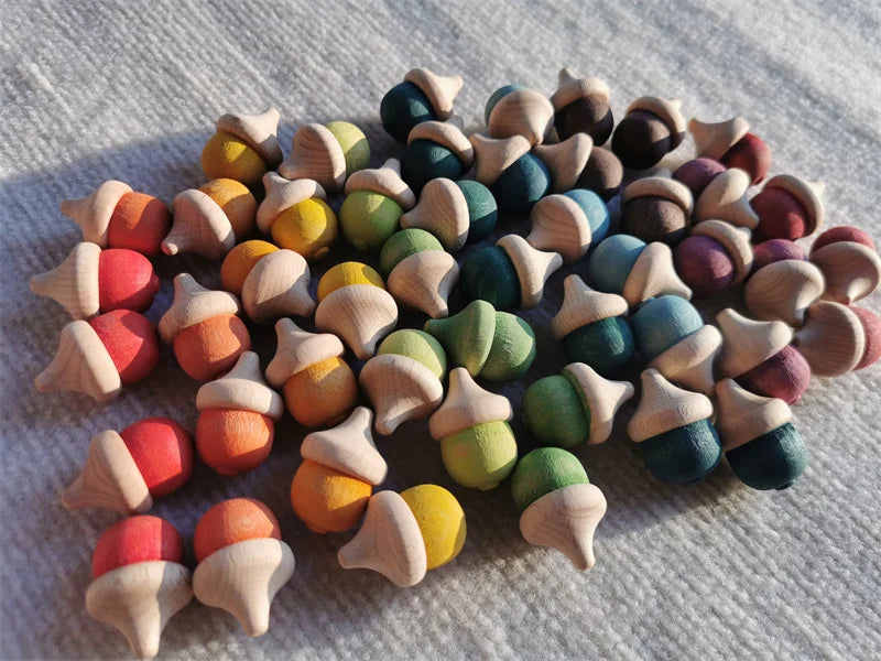 Colorful wooden acorn-shaped toys on a textured surface
