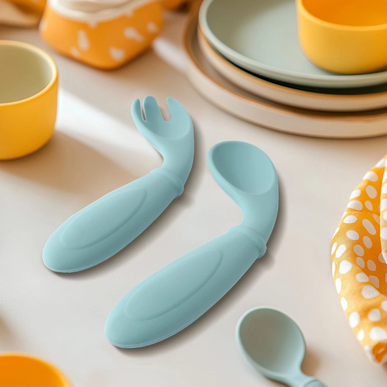 Aqua curved silicone spoon on a table
