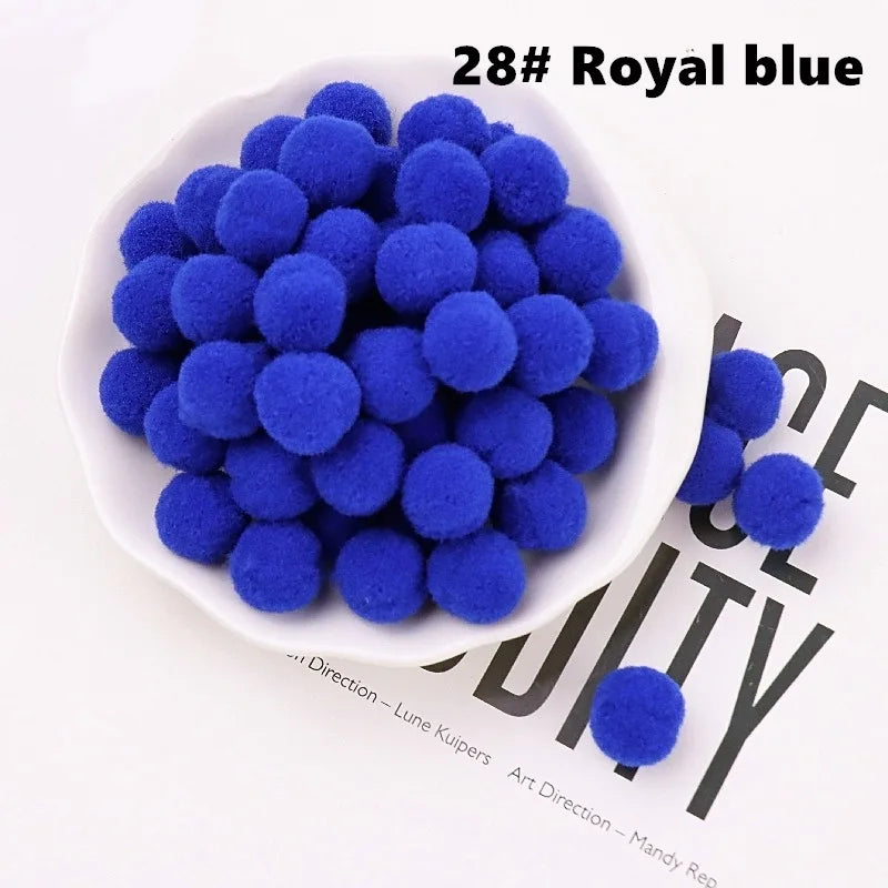 White bowl filled with blue pom-poms on a magazine background