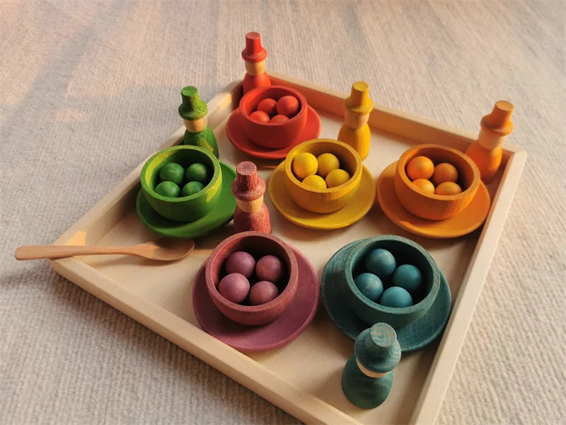 Colorful wooden toy set with bowls and balls on a tray