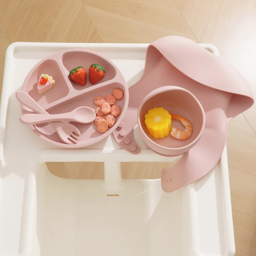 Light pink feeding set on a high chair tray