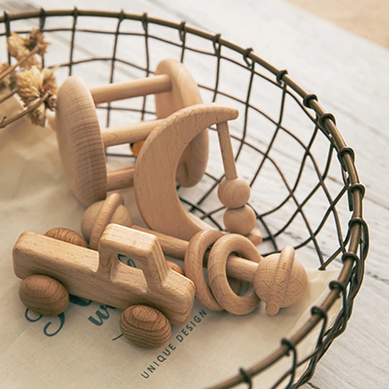 Wooden toys including a car and a boat in a wire basket on a light surface.