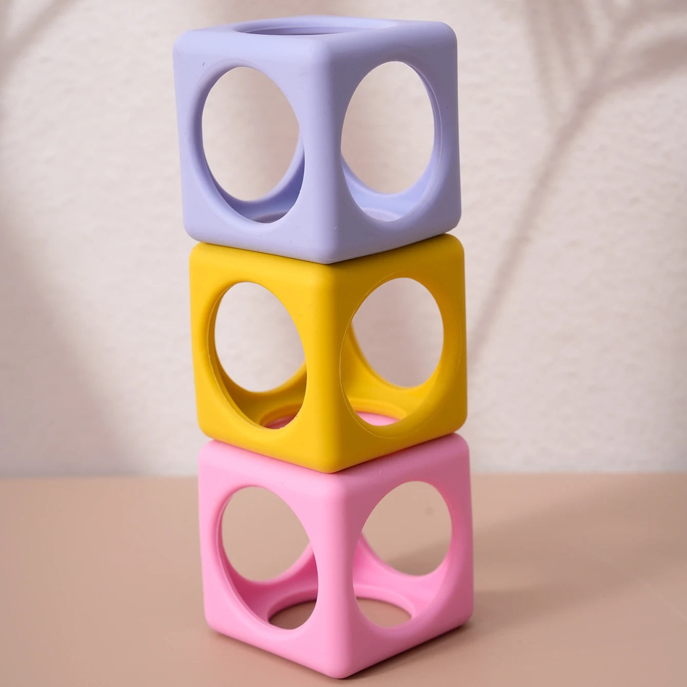 Silicone cube teethers stacked in a tower