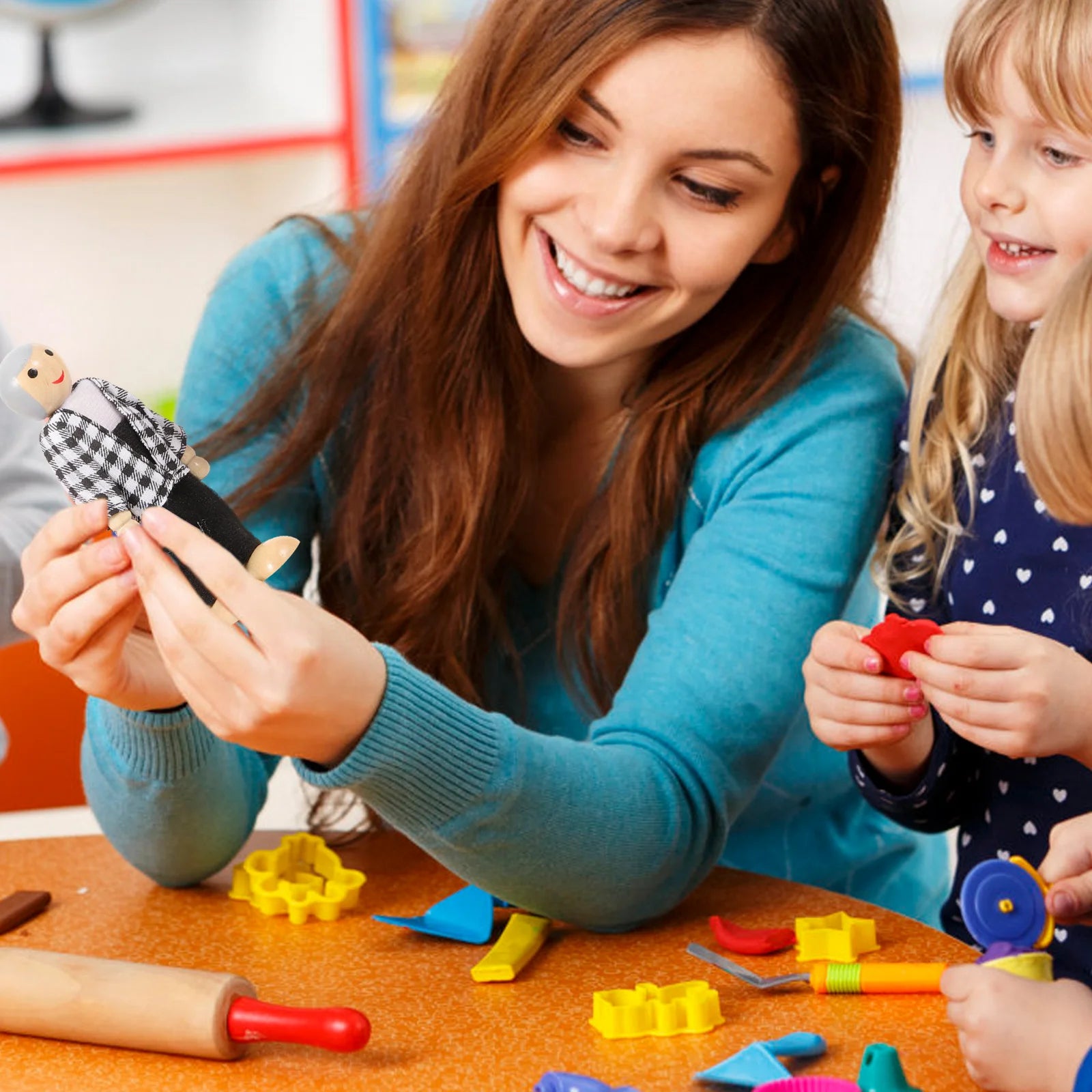 Woman and child playing with toys at a table