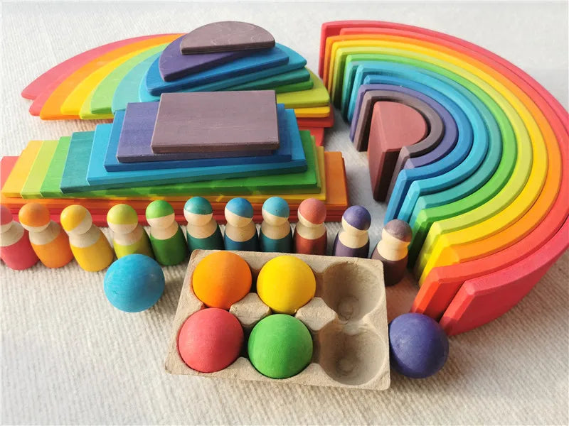 Colorful wooden toys including blocks and balls on a light background
