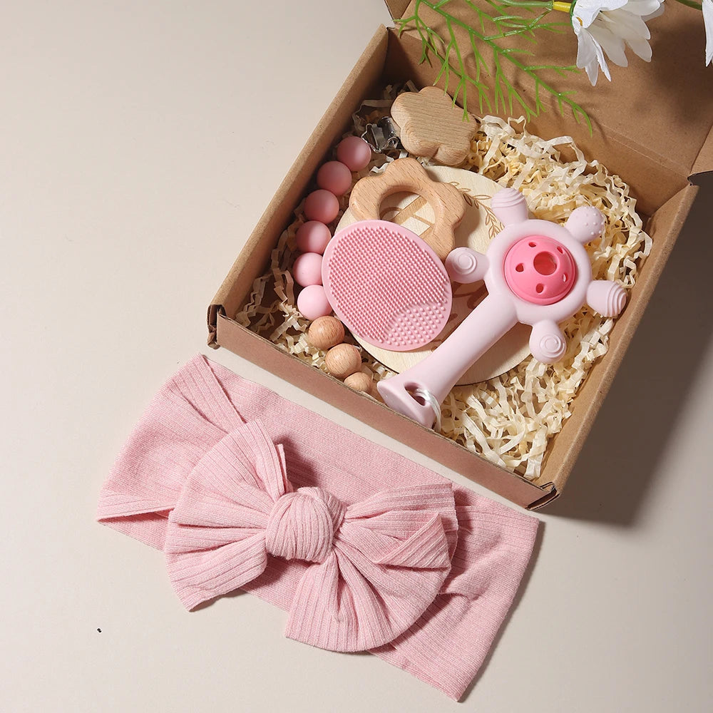 Baby Gift Set with Flower Teether & Pacifier Chain in a craft box, featuring a pink bow and wooden toys, ideal for baby showers.