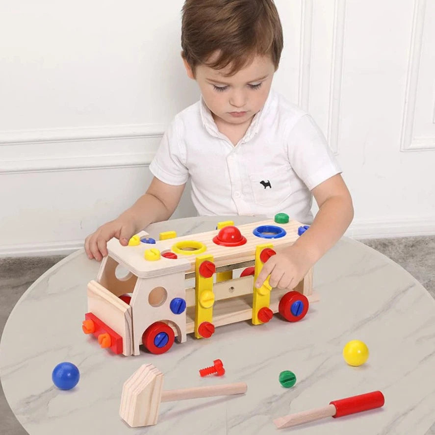 Child playing with Montessori Truck Building Tools Toy, a wooden set promoting fine motor skills and cognitive development through assembly and disassembly play.