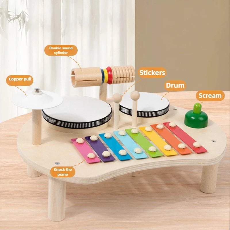 Children's wooden musical toy set with various components labeled on a wooden surface.