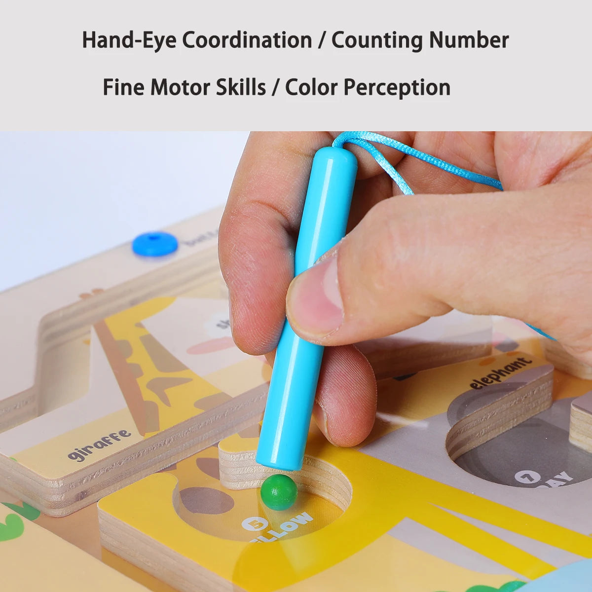 Hand holding a blue toy tool interacting with a wooden educational board game.