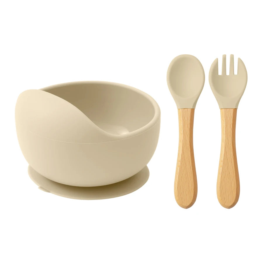 Cream silicone suction bowl with wooden spoon and fork